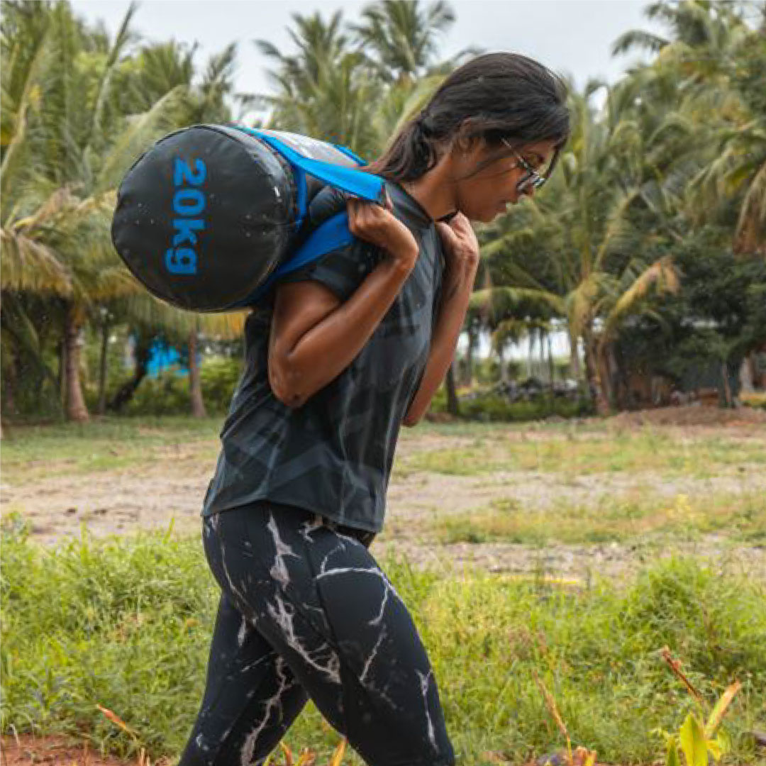 Guest carrying sandbag during Sol Fitness functional workout
