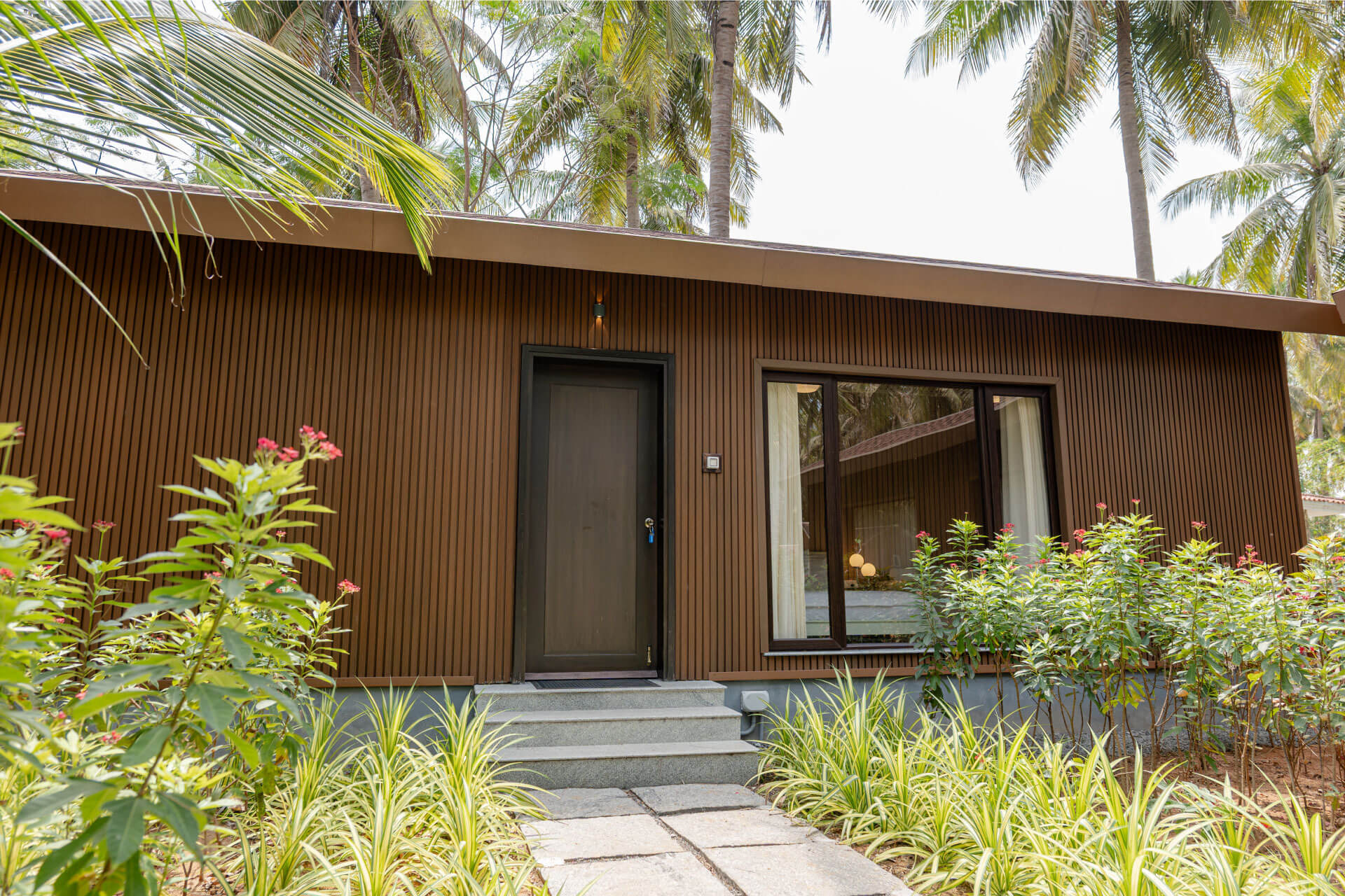 Exterior of tropical villa at Sol Fitness Resorts with garden path